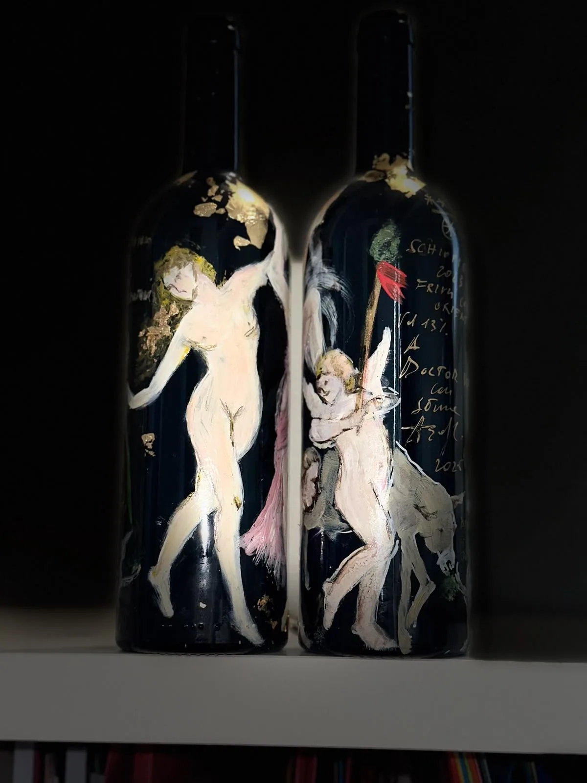 Due bottiglie dipinte: una figura nuda e, sull’altra, un putto e una dedica scritta a mano